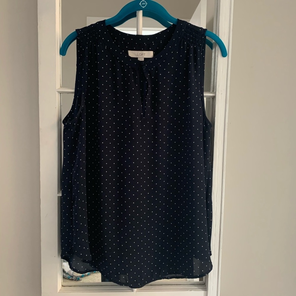 Navy and white polka dotted sleeveless blouse